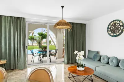 a living room with a couch and a table at Le Palme Beach Rhodes in Haraki