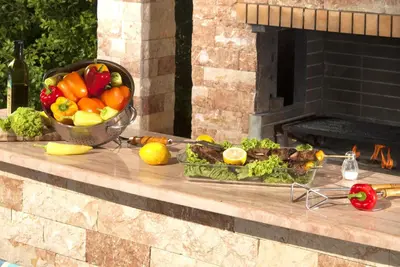 a bowl of fruit and vegetables on a table with a fireplace at Villa Angelina in Pefki Rhodes