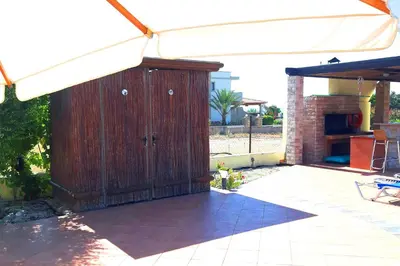 a wooden shed with a white canopy on a patio at Villa Angelina in Pefki Rhodes