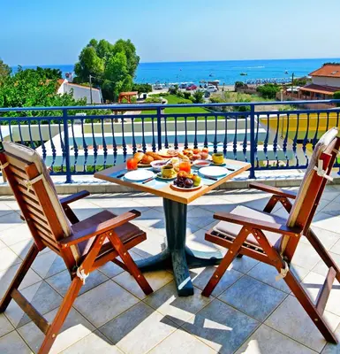 a table with fruit on it on a balcony at Villa Angelina in Pefki Rhodes