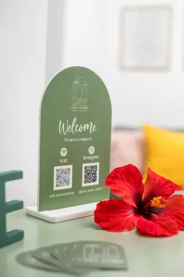 a red flower sitting next to a sign on a table at CasaVerde Central Apartment in Rhodes Town