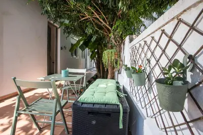 a balcony with a bench and a table and chairs at CasaVerde Central Apartment in Rhodes Town