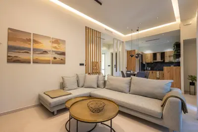 a living room with a couch and a table at Kallithea Blue in Koskinou
