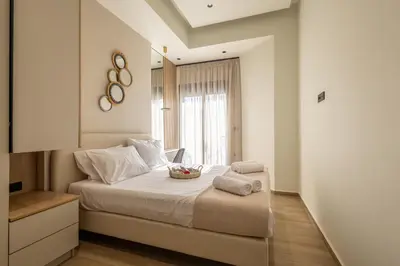 a bedroom with a bed with a bowl of fruit on it at Kallithea Blue in Koskinou