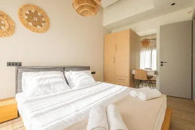 a bedroom with a bed with two towels on it at Kallithea Blue in Koskinou