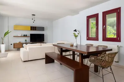 a living room with a table and a couch at Villa Olive in Koskinou