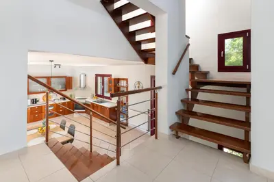 a staircase in a home with white walls at Villa Olive in Koskinou