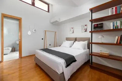 a bedroom with a bed and a book shelf at Villa Olive in Koskinou