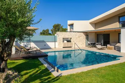 a swimming pool in the backyard of a house at Alma Luxury Villas in Ialyssos