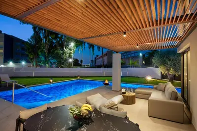 a house with a swimming pool at night at Alma Luxury Villas in Ialyssos