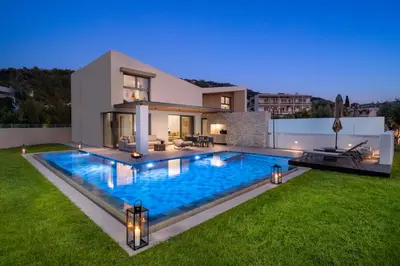 a house with a swimming pool in the yard at Alma Luxury Villas in Ialyssos