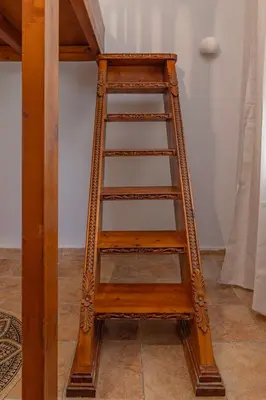 a wooden ladder leaning up against a wall at Koskinou Residence in Koskinou