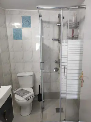 a bathroom with a toilet and a glass shower at Koskinou Residence in Koskinou