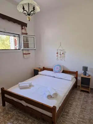a bedroom with a bed with towels on it at ANiko in Kolimbia