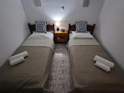 two beds in a small room with at ANiko in Kolimbia