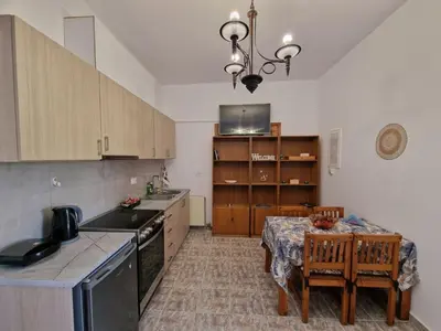 a kitchen with a table and a dining room at ANiko in Kolimbia