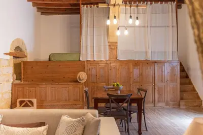 a living room with a table and a couch at La Casa di Varvara e Nikolas in Soroni