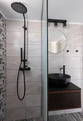 a bathroom with a shower with a black sink at Mini Mansion in Rhodes Town