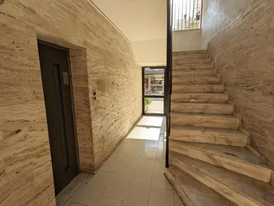 a hallway with stairs in a building with a door at Mini Mansion in Rhodes Town