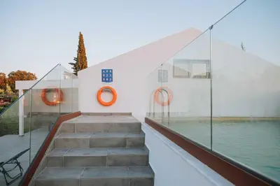 a staircase leading to a building with a pool at Manolis Seaside Villa in Soroni
