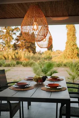 a table with plates and a chandelier hanging over it at Manolis Seaside Villa in Soroni