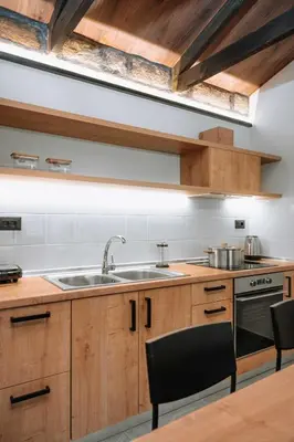 a kitchen with wooden cabinets and a sink at Manolis Seaside Villa in Soroni