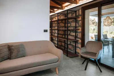 a living room with a couch and a dining room at Manolis Seaside Villa in Soroni