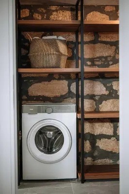 a washing machine on a shelf in a room at Manolis Seaside Villa in Soroni