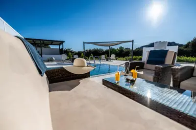 a villa with a swimming pool and a patio at Vigla Kiotari in Kiotari