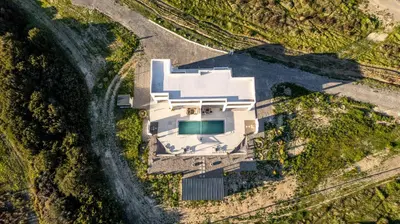 an aerial view of a white house with a pool at Vigla Kiotari in Kiotari