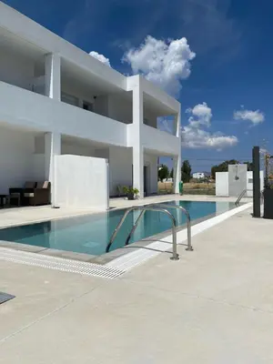 a large white house with a swimming pool at Vigla Kiotari in Kiotari