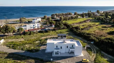 an aerial view of a white house and the ocean at Vigla Kiotari in Kiotari