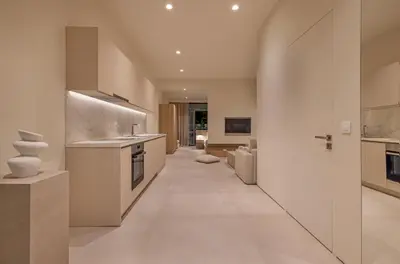 a kitchen with white appliances and a long hallway at Natural Harmony ,Luxury Studio Oasis & Hot Tub in Rhodes Town