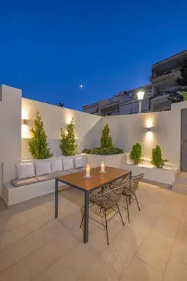 a patio with a wooden table and chairs at Natural Harmony ,Luxury Studio Oasis & Hot Tub in Rhodes Town