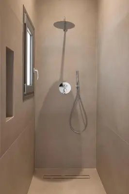 a shower with a shower head in a bathroom at Natural Harmony ,Luxury Studio Oasis & Hot Tub in Rhodes Town