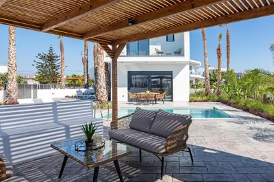 a patio with a couch and a table at Davlakos Villa Eve in Kremasti