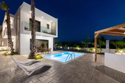 a villa with a swimming pool at night at Davlakos Villa Eve in Kremasti