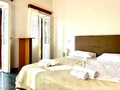 a bedroom with two beds with towels on them at Symi Roots House in Symi