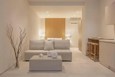 a living room with a couch and a table at Earthy Haven-Minimalist Luxury Studio & Hot Tub in Rhodes Town