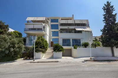 a white building with trees in front of it at Earthy Haven-Minimalist Luxury Studio & Hot Tub in Rhodes Town