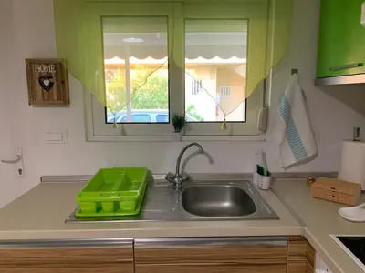 a kitchen with a green tray on a sink at SERENITY House in Faliraki