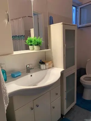 a bathroom with a sink and a toilet and a mirror at SERENITY House in Faliraki