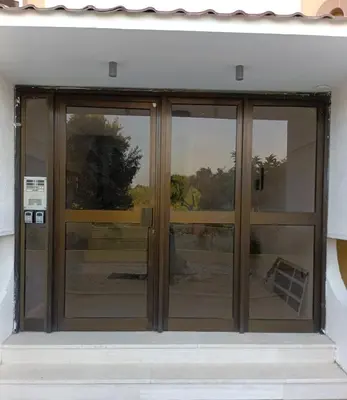 a glass door with three windows on a building at Helene Mirteni in Ialyssos