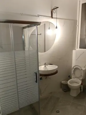 a bathroom with a sink and a toilet at Helene Mirteni in Ialyssos