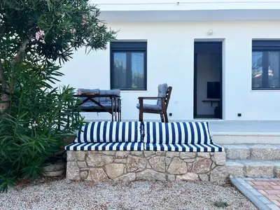 a blue and white couch sitting in front of a house at ELÉNAS slow living villa in Faliraki