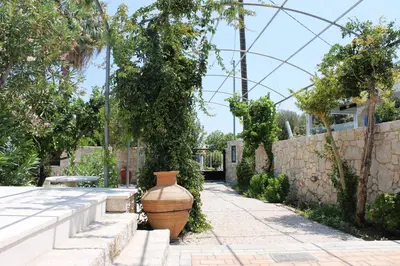 a large vase sitting in the middle of a garden at ELÉNAS slow living villa in Faliraki