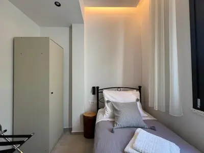 a bedroom with a bed with white sheets and pillows at ELÉNAS slow living villa in Faliraki