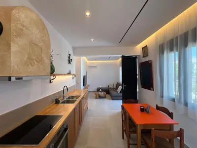 a kitchen with a sink and a table in a room at ELÉNAS slow living villa in Faliraki