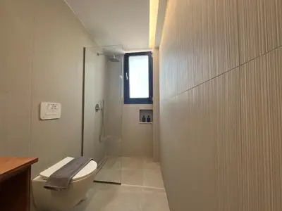 a bathroom with a toilet and a glass shower at ELÉNAS slow living villa in Faliraki