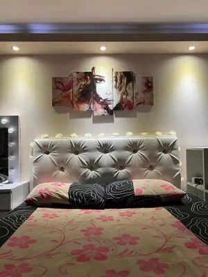 a bedroom with a bed and some paintings on the wall at Cozy Rhodes Studio in Rhodes Town